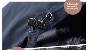 Detail of adjustable drawstring toggle on navy blue hooded jacket with plaid lining