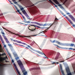 Close-up of a men's classic red and blue plaid cotton shirt with buttoned chest pocket