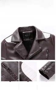 Detail view of brown PU leather jacket with white quilted shoulder patches and metal zipper