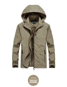 Detail of khaki windbreaker with mesh lining, zipper pockets, and sleeve badge