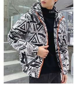 Detail of winter down jacket with graffiti print and vibrant orange zipper accent