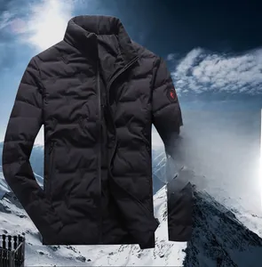 Detail of black quilted down jacket with high collar and red logo on the sleeve