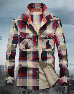 Detail of red and navy plaid cotton shirt showing buttoned chest pockets and embroidery