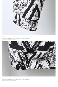 Detail of white down jacket featuring urban print, ribbed cuffs, and metal snap buttons