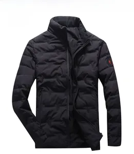 Detail view of black quilted winter jacket with stand collar and red sleeve badge