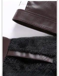 Detailed view of motorcycle jacket hem and thick fleece lining in dark brown