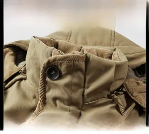 Detailed view of the khaki jacket collar featuring dark brown corduroy lining and button
