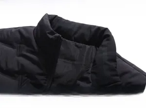 Detailed close-up of the black stand-up collar and high-quality zipper of the winter jacket