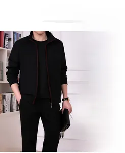 Close-up of black men's tracksuit jacket showing red contrast zipper and ribbed cuffs
