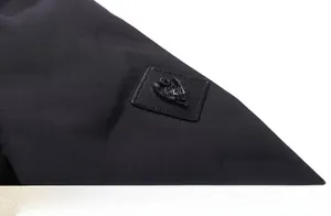 Close-up of windproof fabric and detailed 3D embossed badge on the jacket shoulder
