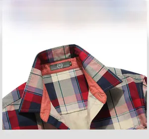 Close-up of the collar and stitching on a classic red and navy plaid cotton shirt