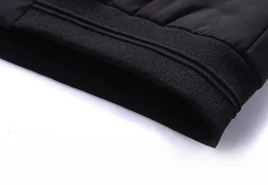 Detail of men's winter jacket showing the elastic ribbed hem and high-quality stitching