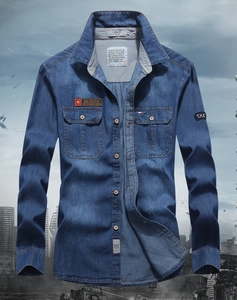 Detail of blue denim shirt showing double chest pockets and red star fashion badges