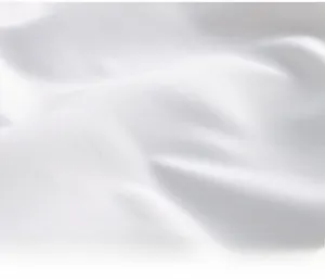 Dettaglio macro del tessuto in cotone bianco con consistenza liscia e pieghe morbide