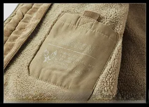 Detail of winter jacket pocket with fashion print on corduroy and warm fleece lining