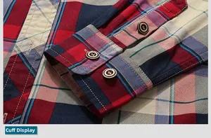 Detailed close-up of red and blue plaid shirt cuffs with engraved dark brown buttons
