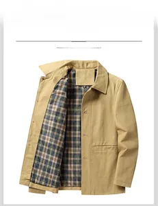 Detail of khaki cotton work jacket featuring classic plaid lining and front patch pockets