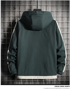 Back view of dark green hooded jacket with beige contrast stitching and elastic cuffs