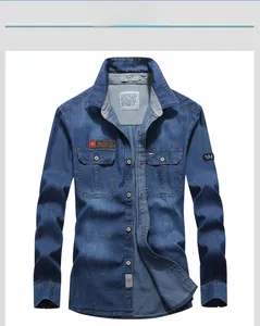 Close-up of blue cotton denim shirt with dual flap pockets and fashion patch detailing