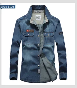 Detail of grey-blue denim shirt with chest pockets and fashion patch embellishments