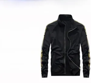 Detail of men's black sports jacket with gold freedom stripes on the sleeve