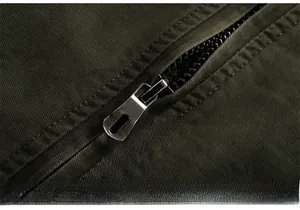 Detail of durable silver metal zipper on army green heavy-duty fleece-lined jacket