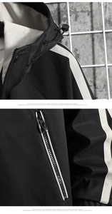 Detail view of black hooded jacket with contrast side stripes and adjustable drawstrings