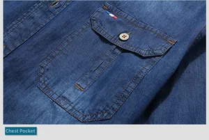 Detail of blue denim shirt chest pocket with contrast orange stitching and button