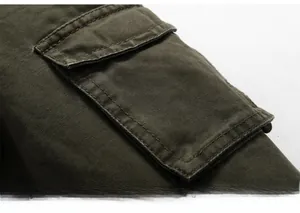 Detail of army green military jacket featuring heavy duty cotton fabric and cargo arm pocket