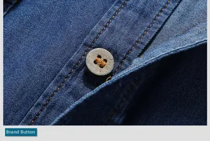 Macro shot of brown wooden buttons and orange contrast stitching on blue denim shirt