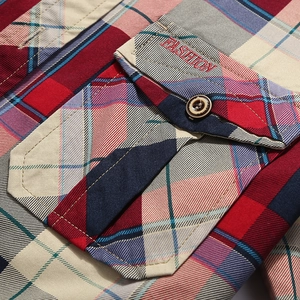 Close-up of men's plaid shirt with front flap pocket and red Fashion embroidery