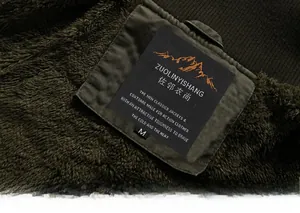 Detail view of thickened fleece lining in dark olive green men jacket for winter warmth