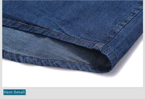 Close-up of denim shirt hemline with classic gold double-stitch sewing and twill texture