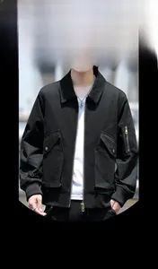 Close-up detail of casual black utility jacket featuring sleeve zipper pocket and rib cuffs