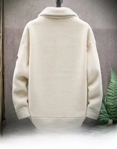 Detail view of winter beige fleece jacket back with thick sherpa texture and turn-down collar