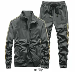 Detail of grey men's tracksuit showing golden Freedom text on sleeves and ribbed cuffs