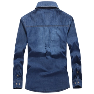 Back view of men's blue cotton denim shirt featuring box pleats and horizontal yoke