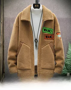 Detail of men's brown fleece jacket with WAND patch embroidery and utility pockets
