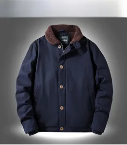 Detail of navy workwear jacket featuring brown sherpa collar and white ARMY print