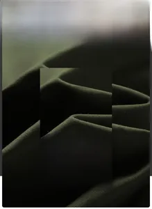 Detailed macro view of dark green premium washed cotton fabric texture and weave
