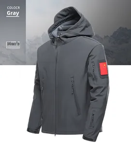 Detail of grey tactical softshell jacket with hood, zipper pockets and flag patch