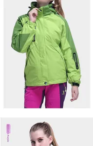 Detail of a green waterproof jacket for women with purple pants and velcro cuffs