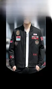 Detail of military style jacket featuring vibrant letter embroidery and ribbed cuffs