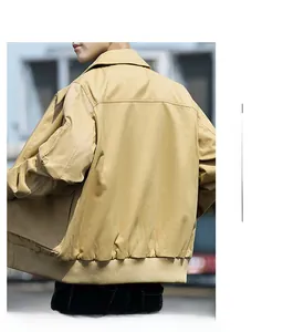 Side view of men's khaki cotton pilot jacket with ribbed cuffs and metallic zipper