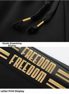 Detail of black sports trousers with freedom golden print and yellow tipped drawstring