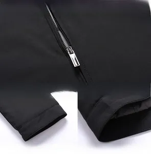 Detailed views of silver metal zipper, straight cuffs and hem on black business jacket