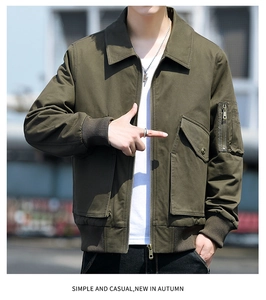 Detail view of military green cotton jacket showing zipper sleeve pocket and utility style
