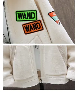 Close-up of lamb wool jacket with WAND patch embroidery and zipper pocket details