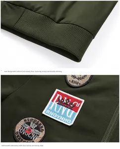 Detail of olive green military jacket showing ribbed hem and vintage embroidery craftsmanship