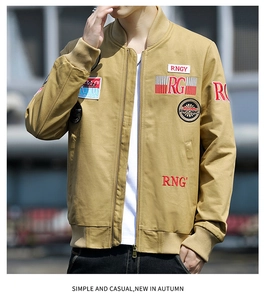 Close-up of khaki military jacket featuring embroidered patches and ribbed stand collar